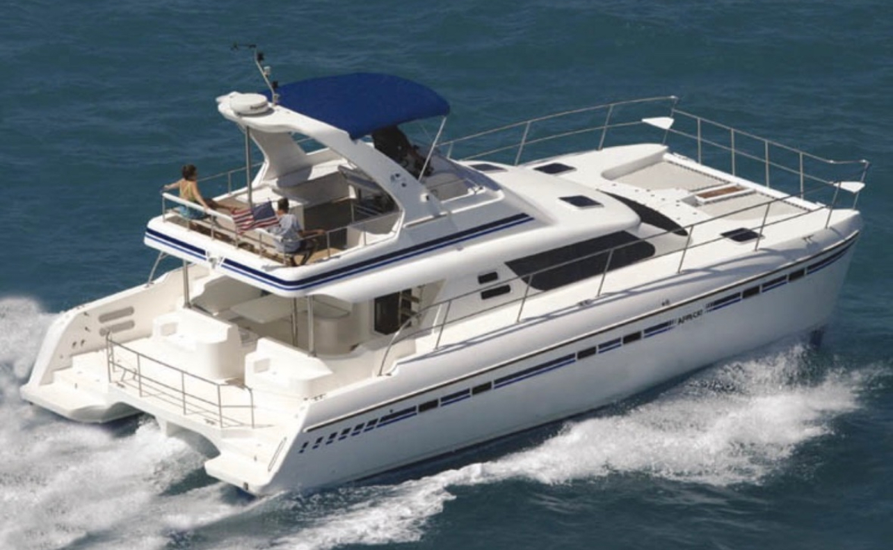 White catamaran cruising across Zanzibar's turquoise water