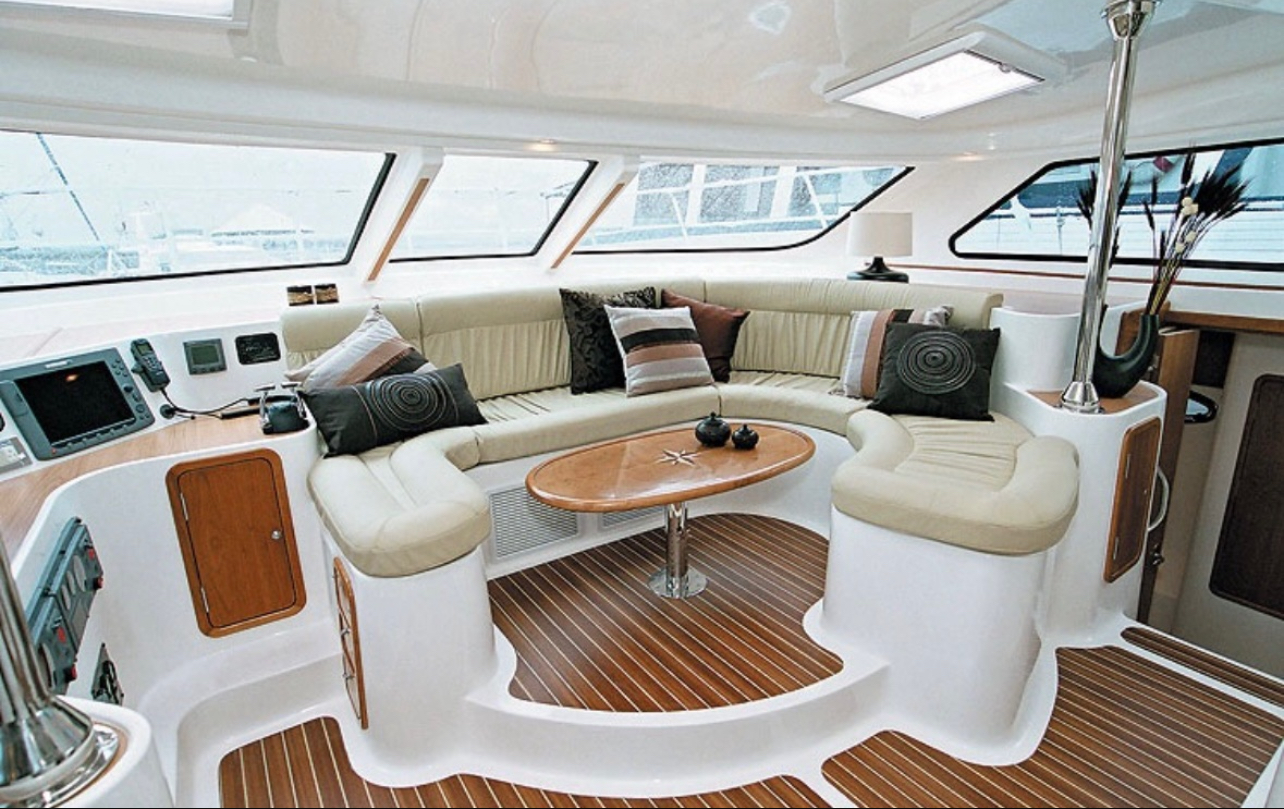 Catamaran salon with seating and teak floor