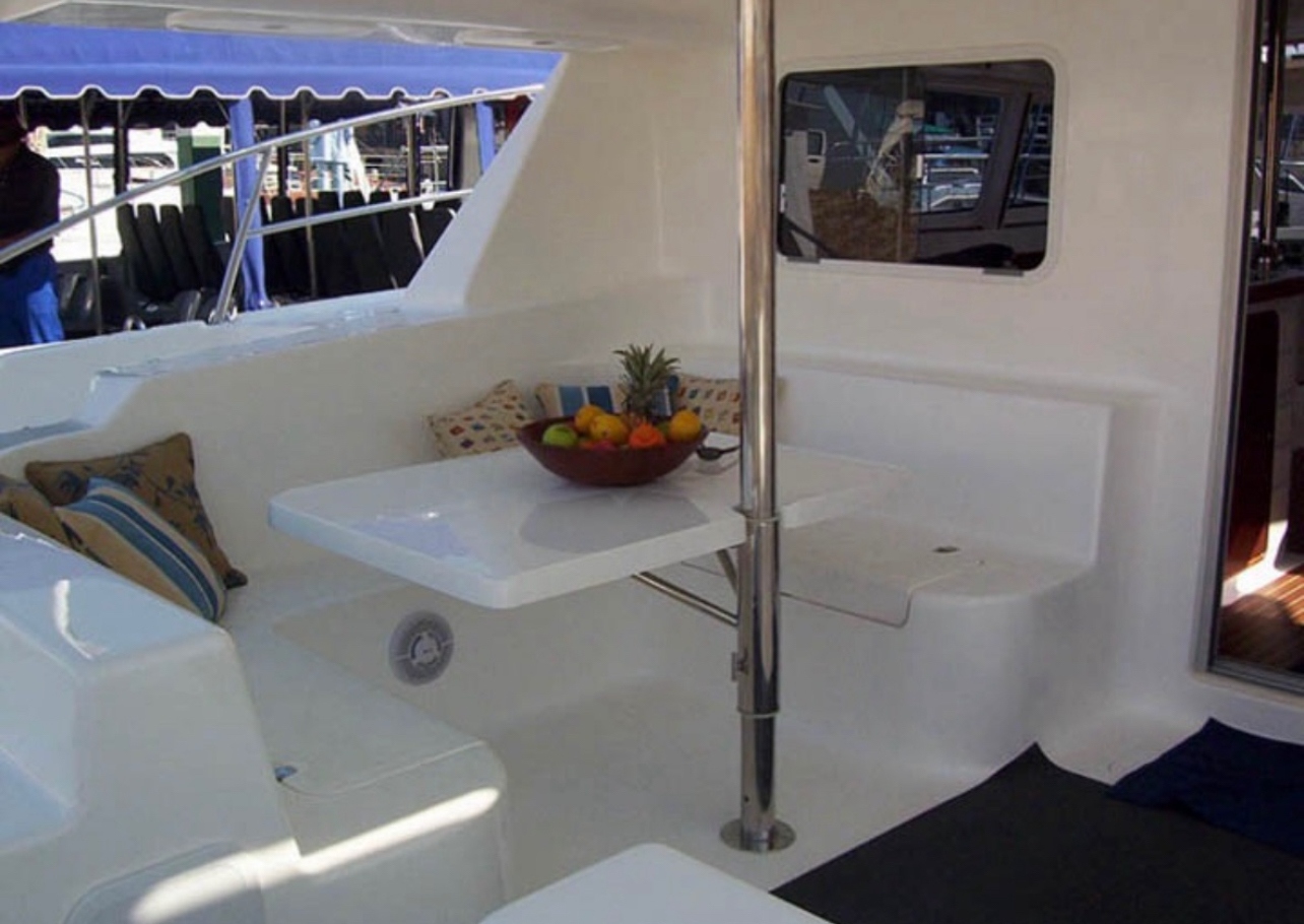 Outdoor dining table on the catamaran deck